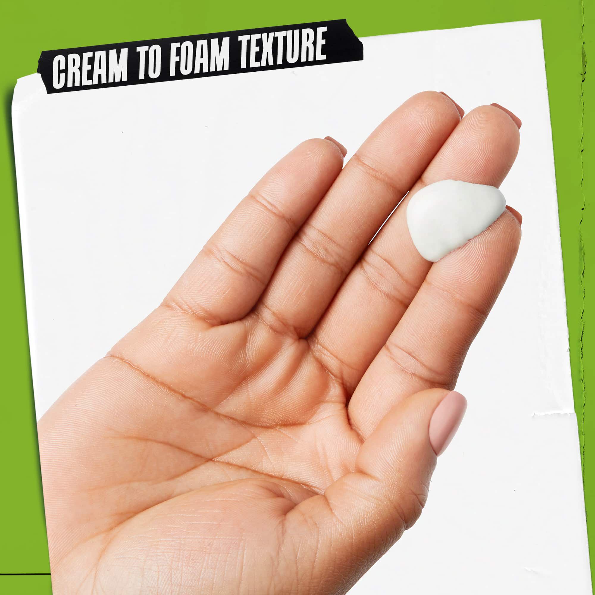 Una mano con Rare Earth Deep Pore Daily Cleanser. Il testo sottolinea: "Texture da crema a schiuma".