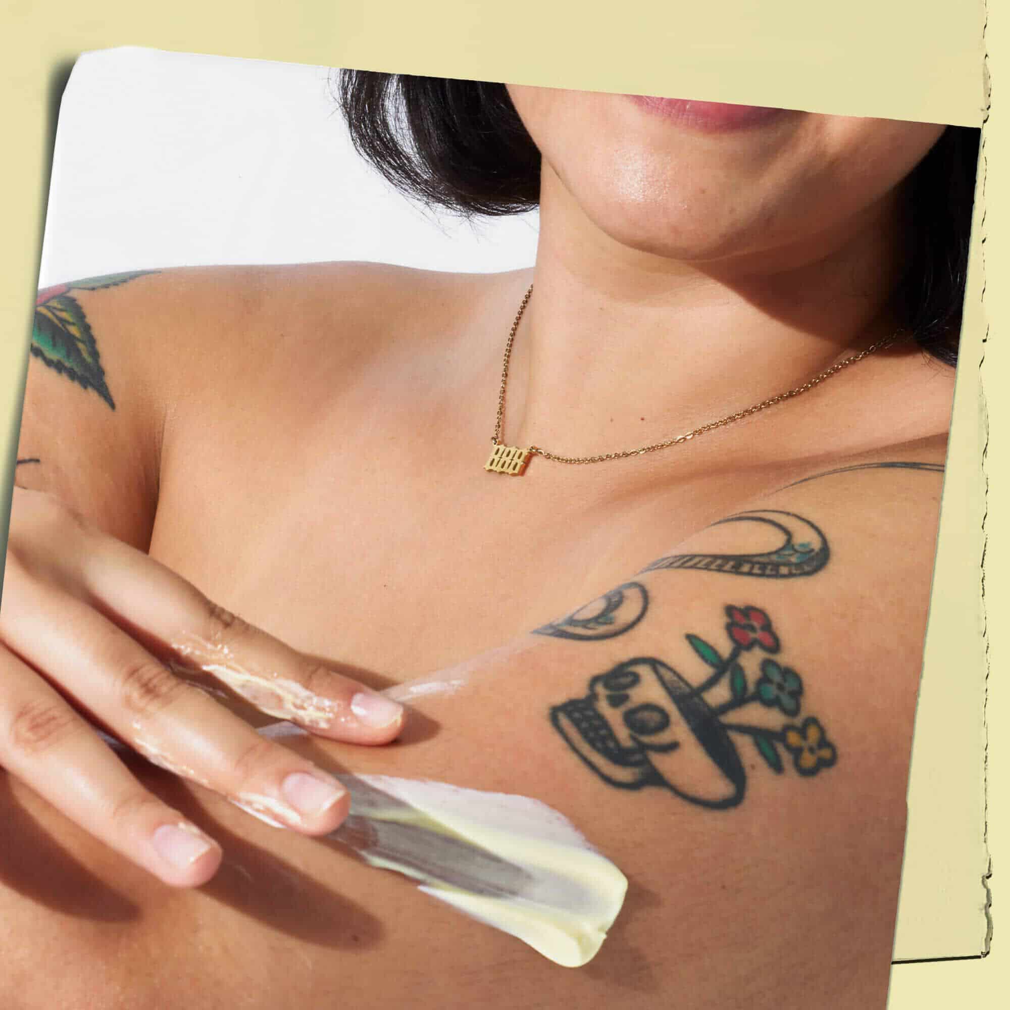 Modello tatuato con la texture della lozione per il corpo Kiehl's Creme de Corps sulla pelle